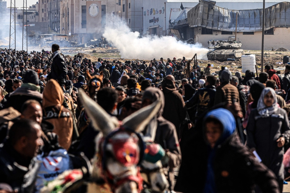 An Israeli tank rolls along a position as Palestinians flee Khan Yunis in the southern Gaza Strip January 26, 2024, amid ongoing battles between Israel and the Palestinian group Hamas. — AFP pic