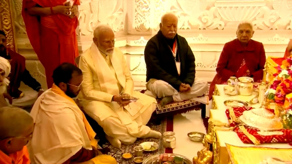 India’s Prime Minister Narendra Modi accompanied by Hindu nationalist organisation Rashtriya Swayamsevak Sangh (RSS), Mohan Bhagwat takes part in rituals during the opening of a grand temple to the Hindu god Lord Ram in Ayodhya, India, January 22, 2024 in this screen grab from video. — Reuters pic