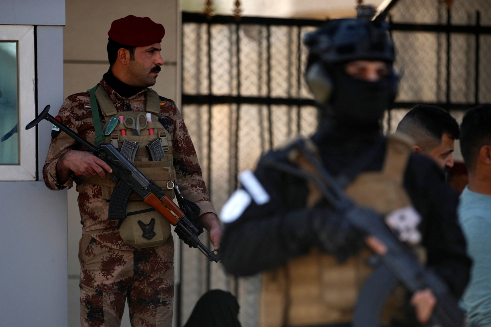 A paramilitary of the Hashed al-shaabi (Popular Mobilisation) forces stands guard during the funeral of a comrade, who died in American air strikes targeting Iran-backed groups the day before, at the Hashed al-shaabi forces’ headquarters in Baghdad on January 25, 2024. — AFP pic