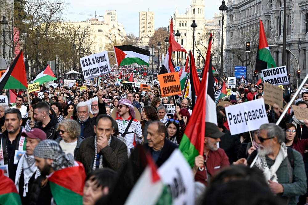 Around 20,000 people marched in Madrid yesterday in support of Palestinians, a day after the UN’s top court said Israel must prevent genocidal acts in its war with Hamas. — AFP pic