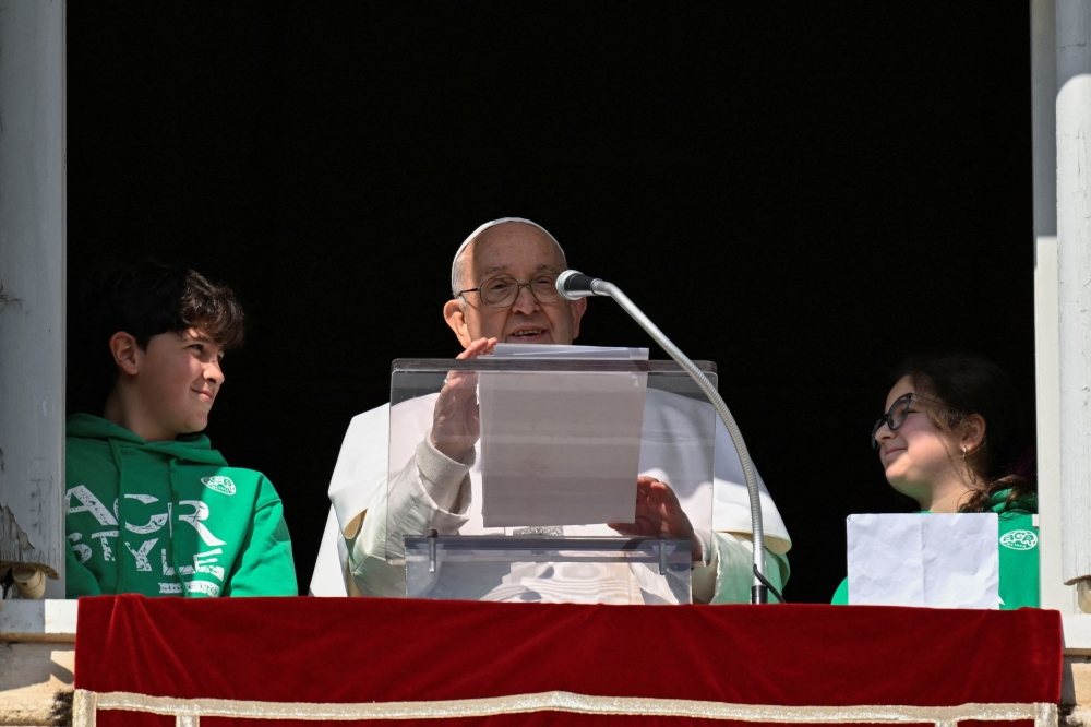 Pope Francis leads the Angelus prayer from his window at the Vatican January 28, 2024. — Vatican Media handout via Reuters pic