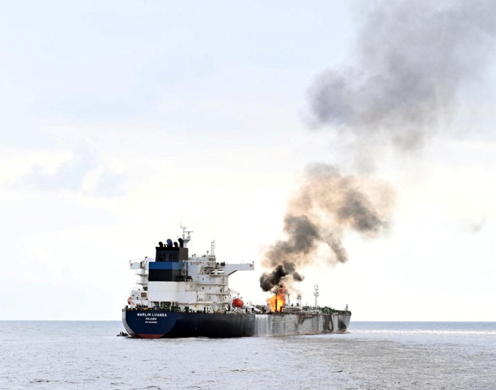 Smoke rises from Marlin Luanda, merchant vessel, after the vessel was struck by a Houthi anti-ship missile, at the location given as Gulf of Aden, in this handout picture released January 27, 2024. ― @indiannavy via X/Handout via Reuters