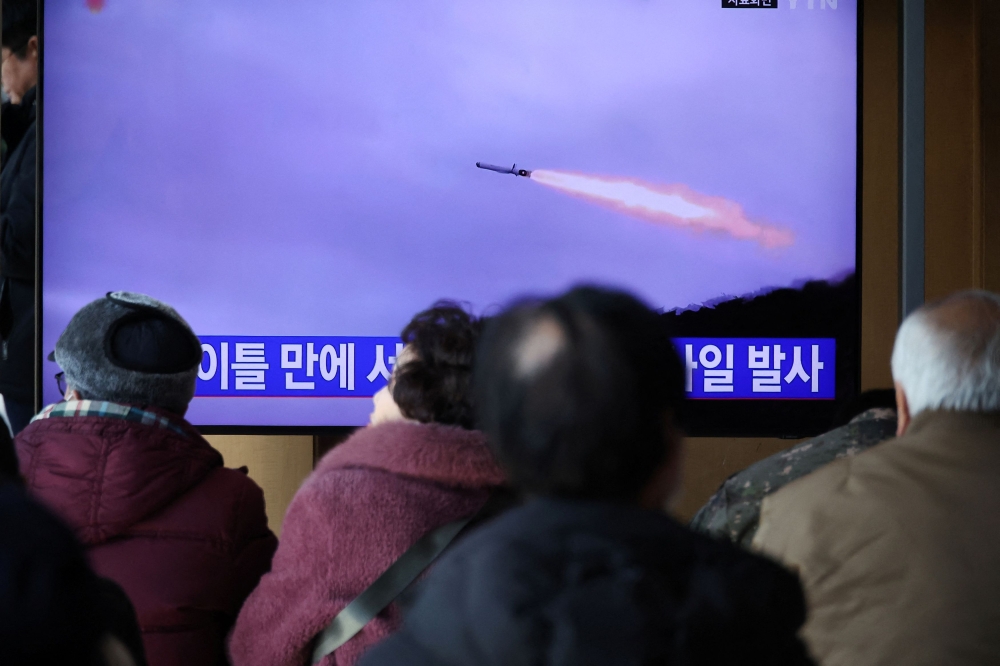 People watch a TV broadcasting a news report on North Korea firing multiple unidentified cruise missiles into the sea off its west coast, at a railway station in Seoul, South Korea January 30, 2024. ― Reuters pic