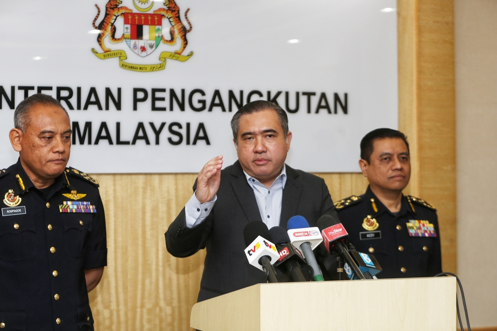 Transport Minister Anthony Loke (centre) speaks during a press conference in Putrajaya January 30, 2024. — Picture by Choo Choy May