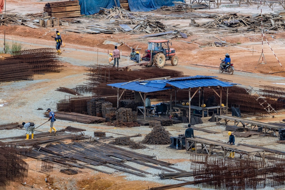 Construction workers are seen at a construction site in Masai January 16, 2024. — Picture by Firdaus Latif