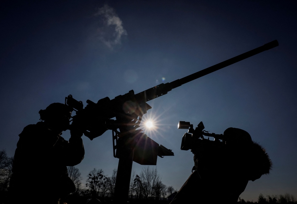 A cameraman films a Ukrainian serviceman from an air defence unit, amid Russia's attack on Ukraine, near Kyiv, Ukraine January 29, 2024. — Reuters pic