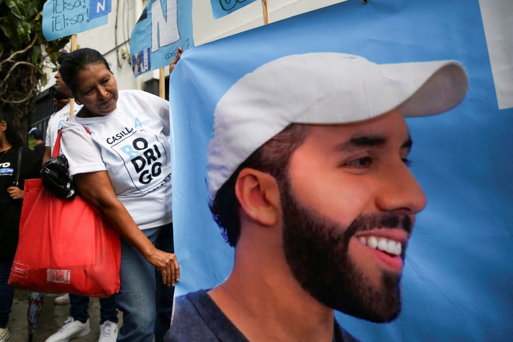 A person holds a poster with a picture of El Salvador's President Nayib Bukele, during a campaign rally of the Nuevas Ideas party in San Salvador, El Salvador, October 20, 2023. — Reuters pic