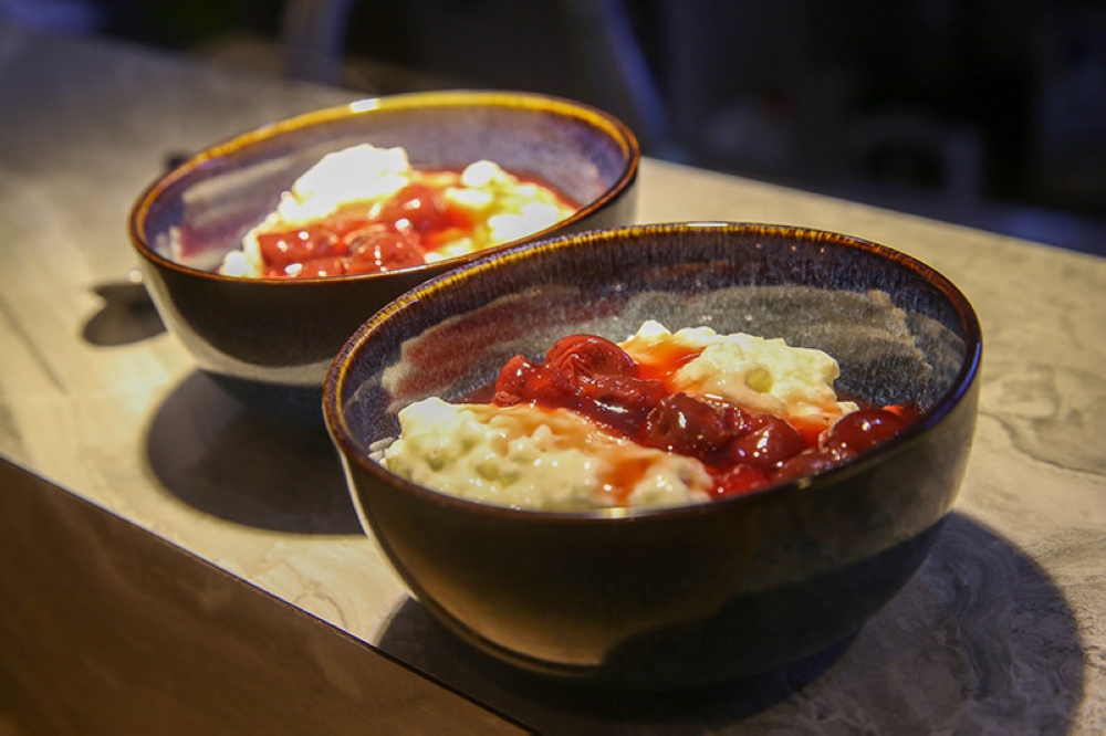 Risalamande, a creamy rice pudding topped with cherry compote, filled with chopped nuts is sometimes available here