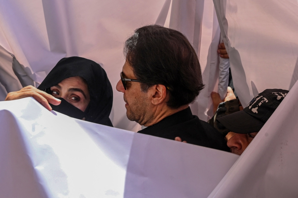 Former Pakistan prime minister Imran Khan and his wife, Bushra Bibi, were sentenced today to 14 years in jail after being found guilty of graft in a case involving gifts he received while premier. — AFP pic