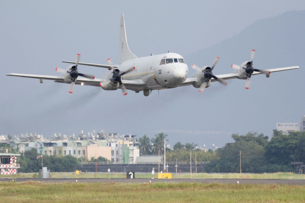 A Taiwan Air Force P-3C Orion aircraft flies past during a demonstration for the media at the Pingtung air base in Pingtung, Taiwan. — Reuters pic