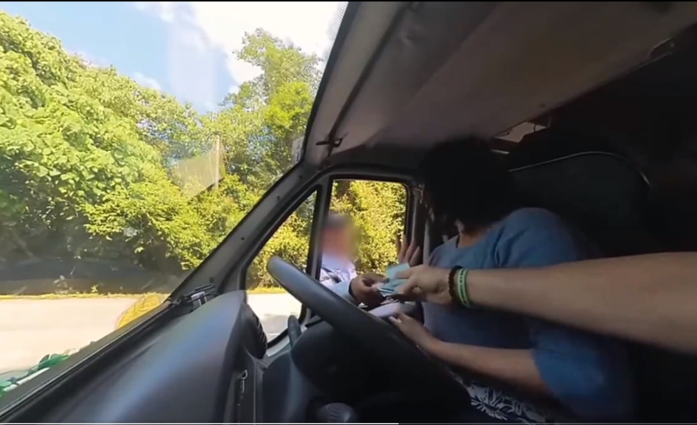 On January 28, the media reported that the Bukit Aman police were investigating a video depicting a traffic officer allegedly accepting RM100 from two foreign tourists, ostensibly to settle a speeding ticket. — Screengrab from social media