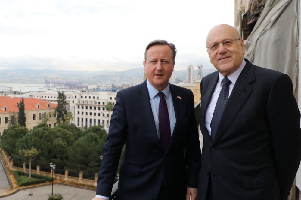 Lebanon’s Prime Minister Najib Mikati (right) poses with Britain’s Foreign Secretary David Cameron before a meeting at the Government Palace in Beirut on February 1, 2024. — AFP pic