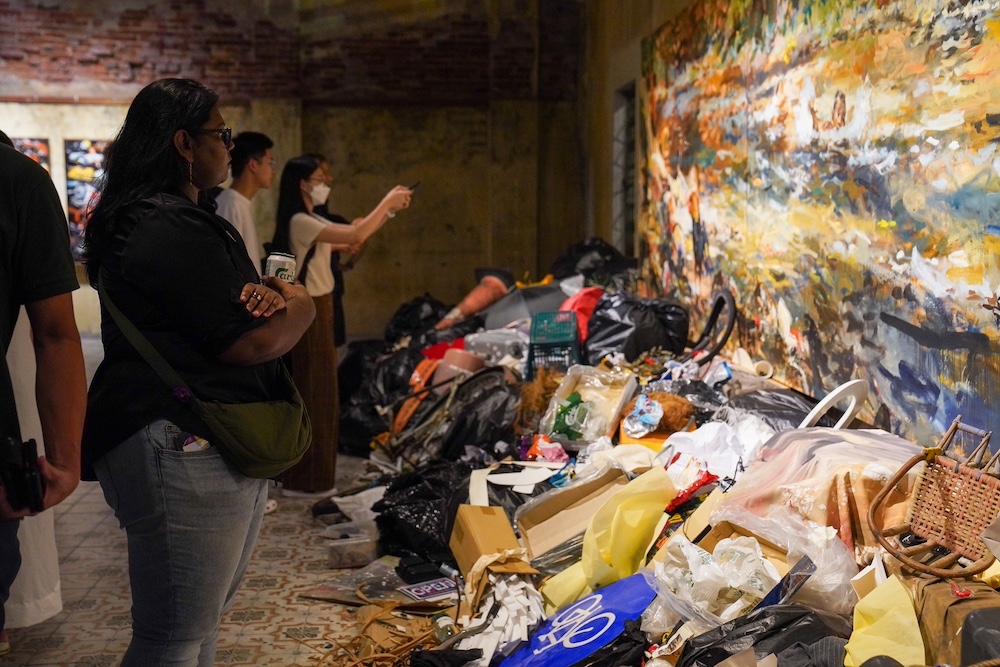 Visitors look at Ernest Zacharevic's installation for “Art is still Rubbish, a decade of Hin”. — Picture courtesy of Antoine Loncle
