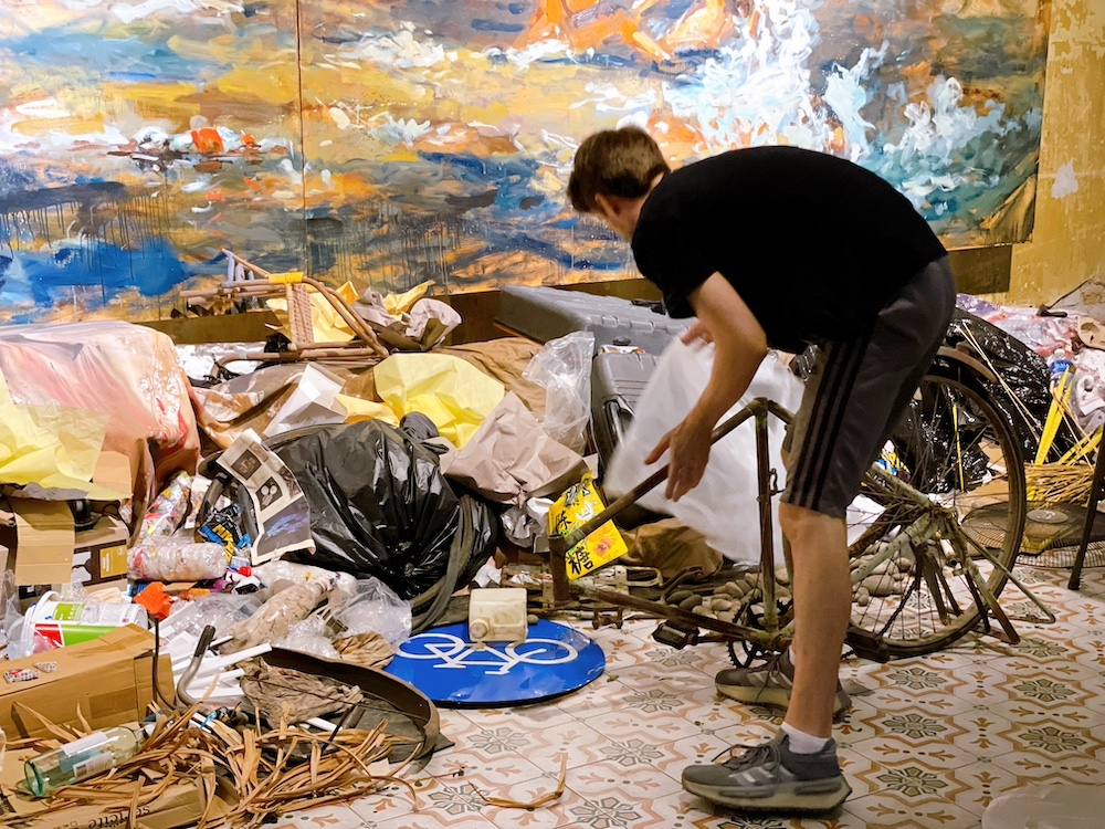 Ernest Zacharevic putting the final touches to his installation for “Art is still Rubbish, a decade of Hin”. — Picture courtesy of Hin Bus Depot