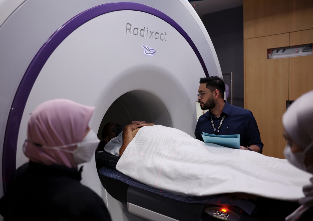 Dr Eznal Iswadi treats a cancer patient with a tomotherapy machine at the Radiotherapy and Oncology Department of Hospital Kuala Lumpur (HKL) recently. — Bernama pic 