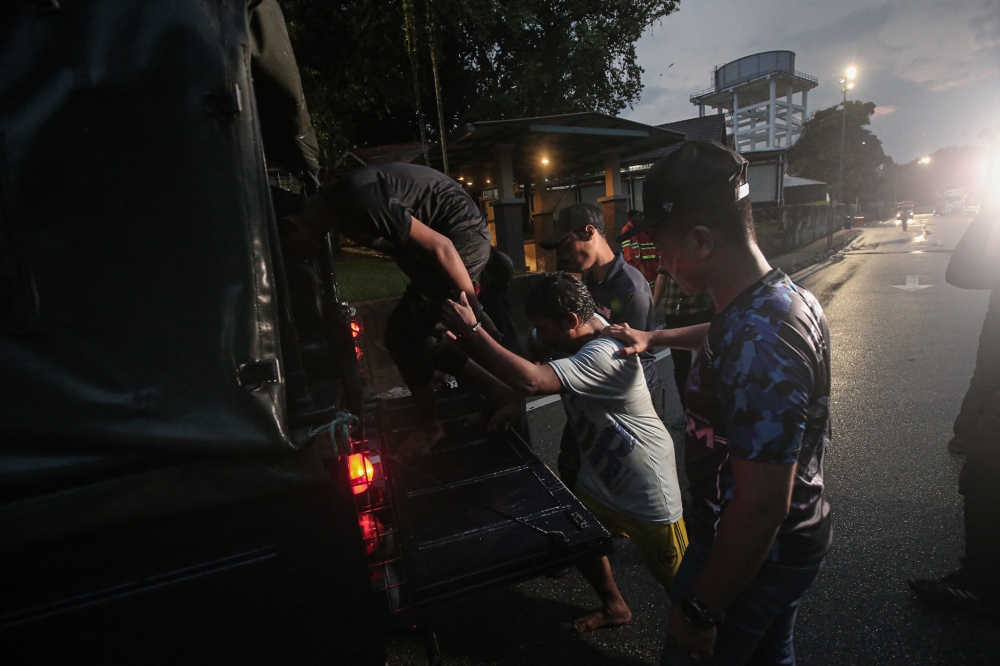 Two undocumented migrants who broke out from the immigration depot in Bidor on Thursday were captured at Tapah rest area, February 2, 2024. — Picture by Farhan Najib