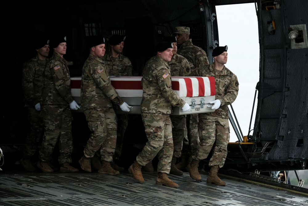Members of the US Honor Guard carry the remains of Army Reserve Sergeants William Rivers, Kennedy Sanders and Breonna Moffett, three US service members who were killed in Jordan during a drone attack carried out by Iran-backed militants, at Dover Air Force Base in Dover, Delaware, US, February 2, 2024. — Reuters pic