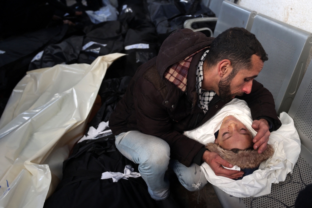 A man mourns over the body of his son killed in Israeli bombardment at the Najjar hospital in Rafah in the southern Gaza Strip on February 3, 2024, as fighting continues between Israel and the Palestinian Hamas group — AFP pic