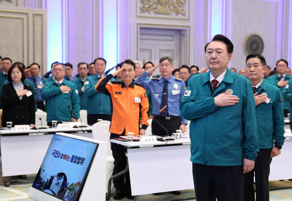 File photo of South Korean President Yoon Suk Yeol saluting the national flag during the central integrated defence meeting in Seoul, South Korea, January 31, 2024. — Reuters pic