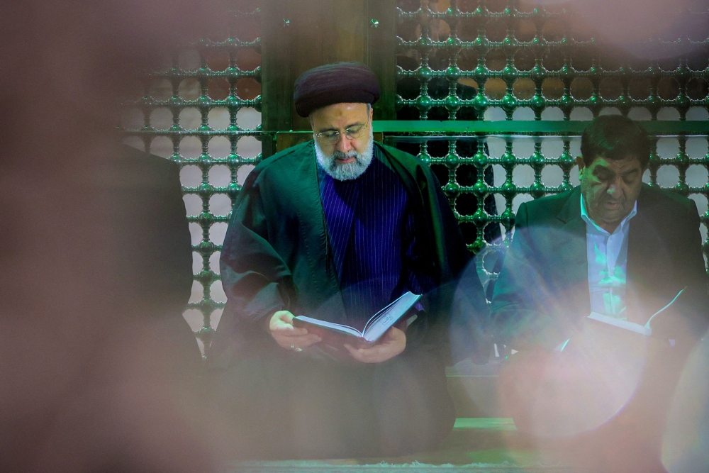 This handout picture taken and released by the Iranian Presidency shows Iran’s President Ebrahim Raisi praying at the tomb of the Islamic Republic’s late founder, Ayatollah Ruhollah Khomeini, in Tehran on January 31, 2024, to mark the 45th anniversary of Khomeini’s return from exile in Paris. — AFP pic