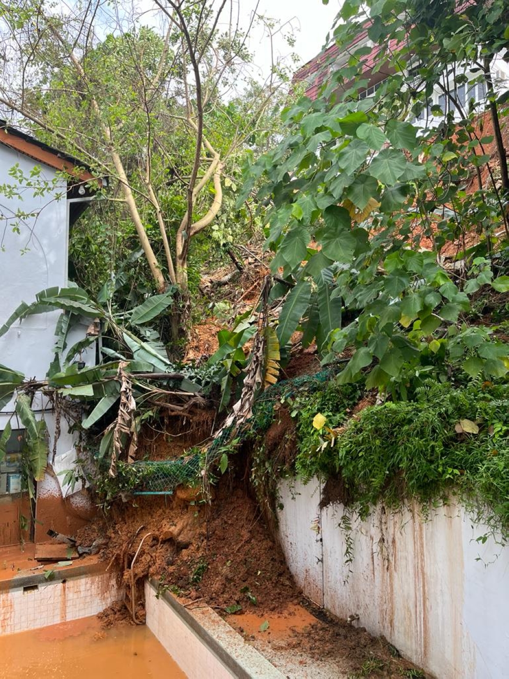Soil from a landslide is pictured in a compound in Taman Bukit Pantai, Bangsar. — Picture courtesy of the Fire and Rescue Department