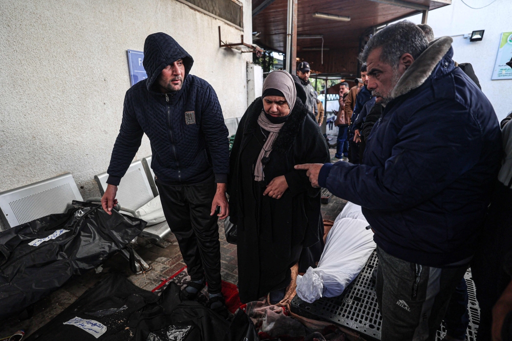 People try to identify the bodies of relative killed in Israeli bombardment in front of the Najjar hospital in Rafah in the southern Gaza Strip on February 3, 2024, as fighting continues between Israel and the Palestinian Hamas group in Gaza. — AFP pic