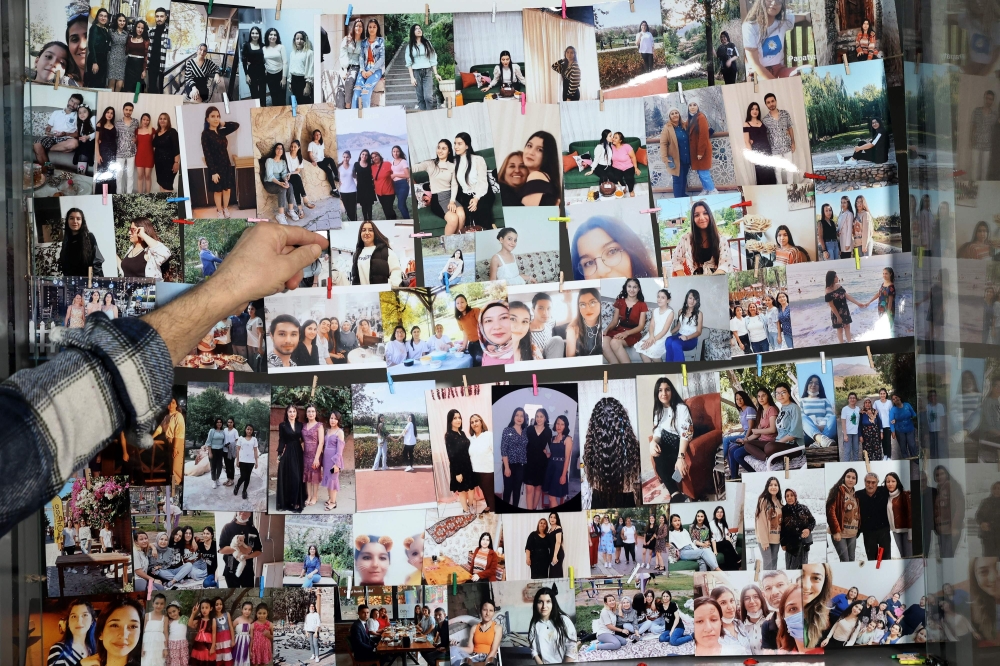 Mesut Hancer, stands infront of photographs of his 15-year-old-daughter Irmak, victim of the earthquake that hit Turkey’s southeast on February 6, 2023, during an interview in Ankara on January 11, 2024. — AFP pic