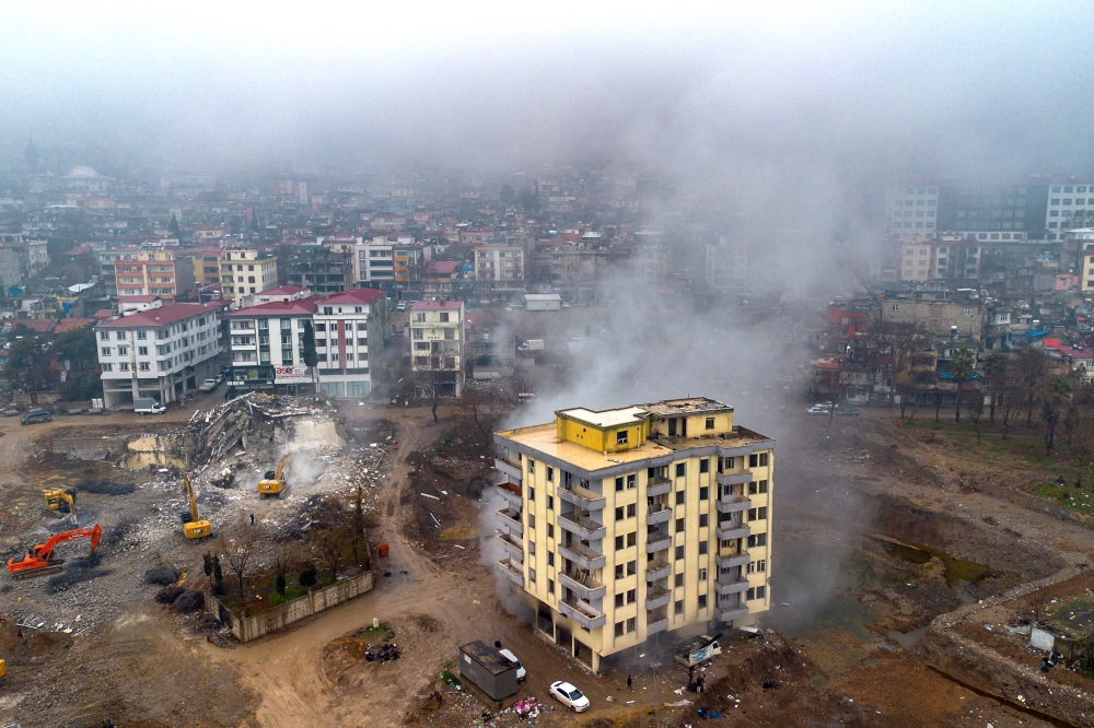 This aerial photograph taken on January 17, 2024 in Kahramanmaras, shows a building being demolished after the February 2023 earthquake. — AFP pic