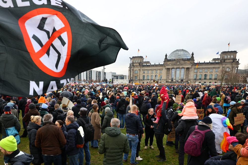 An anti-Nazi banner flutters as people gather outside the Reichstag building, during a rally of the broad alliance ‘Hand in Hand’ under the slogan ‘Wir sind die Brandmauer’ (‘We are the Firewall’) to protest against right-wing extremism and for the protection of democracy, in Berlin, Germany February 3, 2024. — Reuters pic