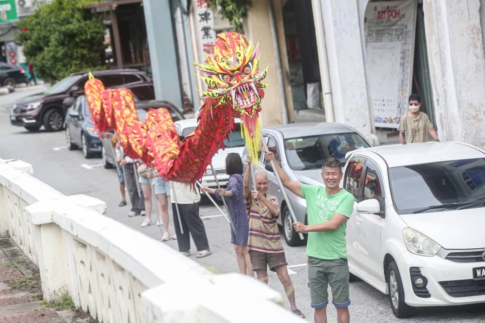 The highlight of the banquet will be a dragon dance led by Tan (in front). — Picture by Farhan Najib