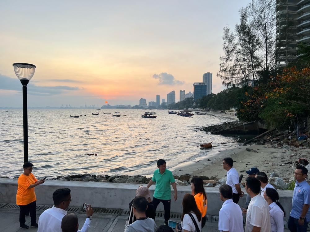 Penang Chief Minister Chow Kon Yeow (in green t-shirt) walking along the Gurney Bay promenade on opening day February 4, 2024 — Picture by Opalyn Mok