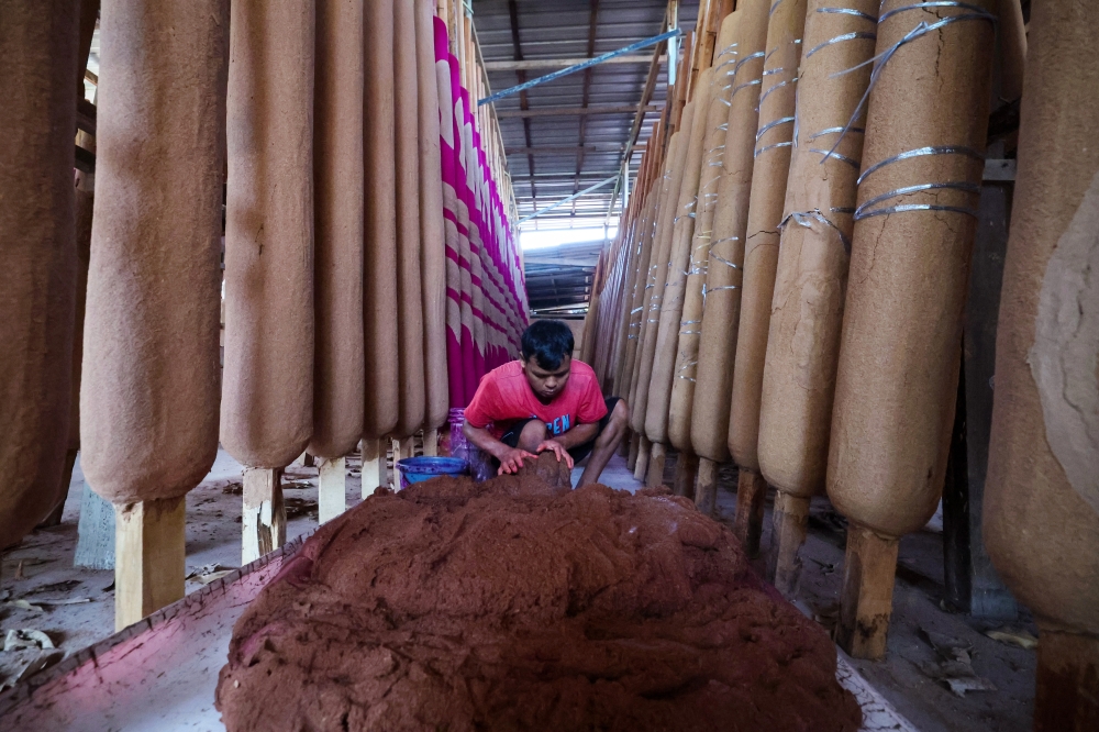 The basic ingredients used for making the dragon joss sticks are wood glue dust and eucalyptus powder mixed with water and then attached to a wooden stick layer by layer until it becomes a joss stick. — Bernama pic