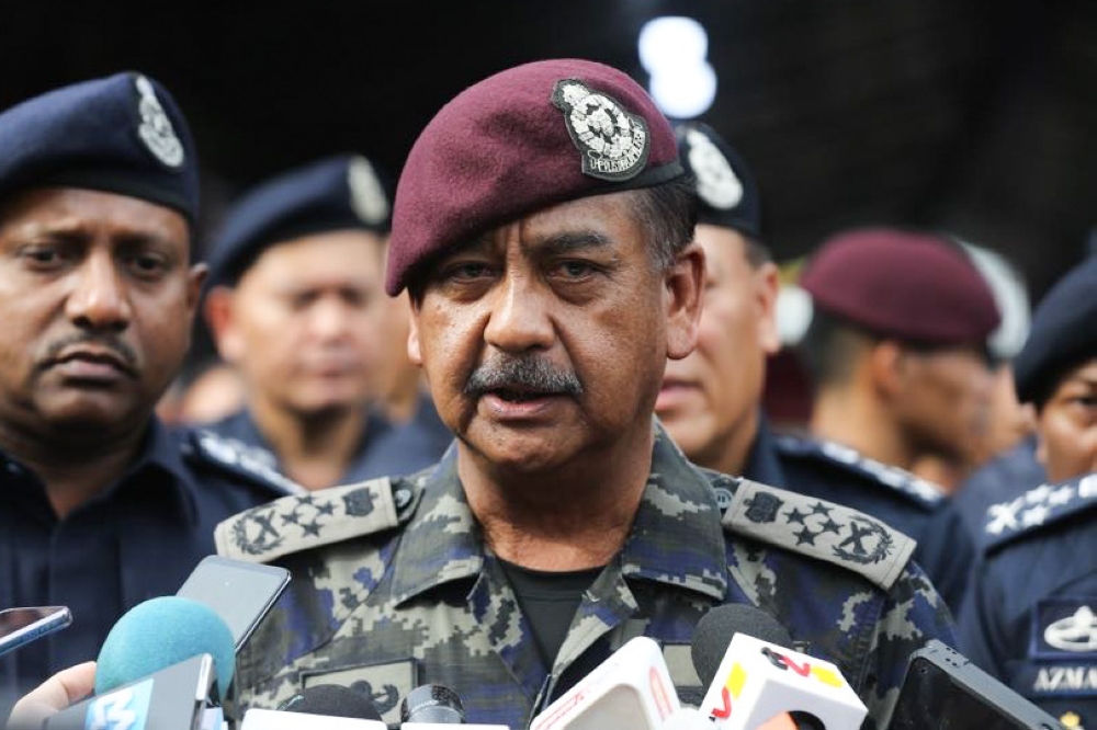 Inspector General of Police, Tan Sri Razarudin Husain speaks to reporters while on a walkabout in Pandamaran February 4,2024. — Picture by Miera Zulyana