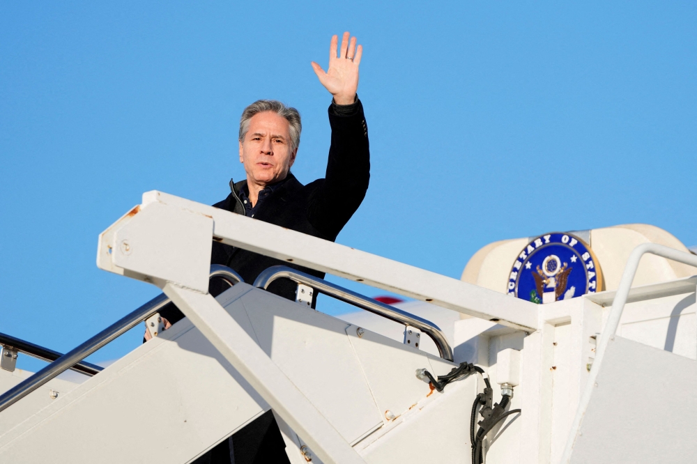 U.S. Secretary of State Antony Blinken waves as he boards a plane, en route to Saudi Arabia, as part of his fifth urgent trip to the Middle East since the war between Israel and the Palestinian Islamist group Hamas in Gaza erupted in October, at Joint Base Andrews, in Maryland February 4, 2024. — Mark Schiefelbein/Pool via Reuters pic