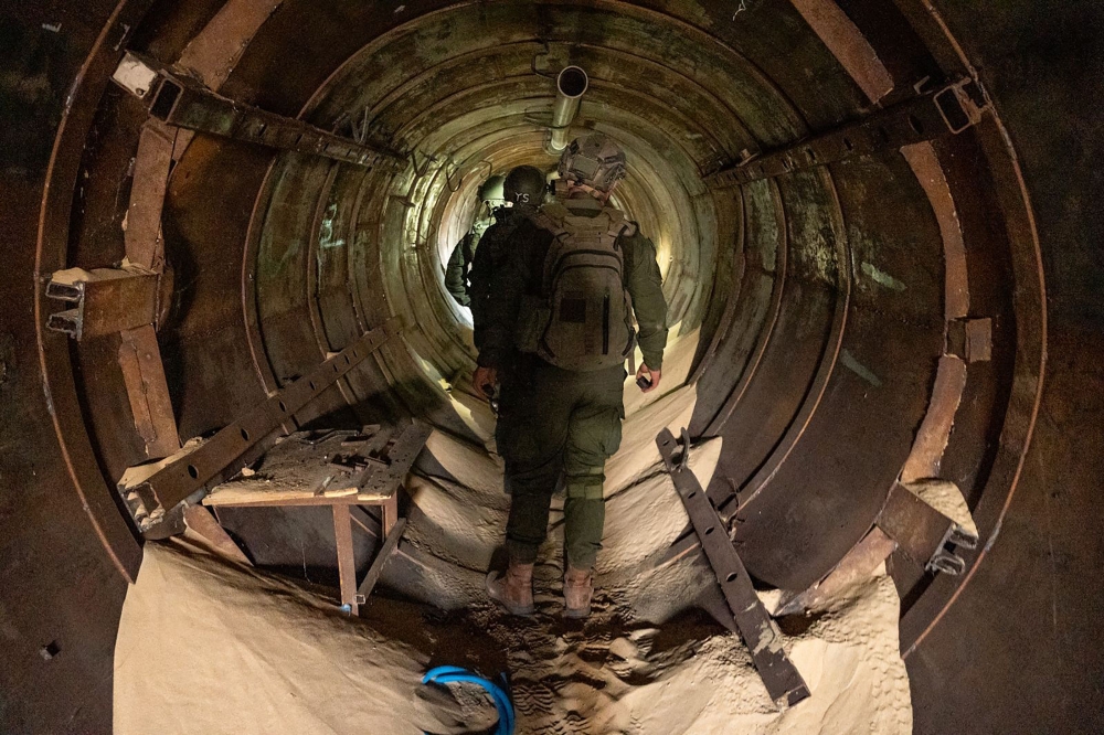 This handout picture released by the Israeli army on February 4, 2024, shows Israeli troops in an underground tunnel, which Israeli forces said they found during a raid in Khan Yunis in the southern Gaza Strip, amid continuing battles between Israel and the Palestinian militant group Hamas. — Israeli Army / AFP pic