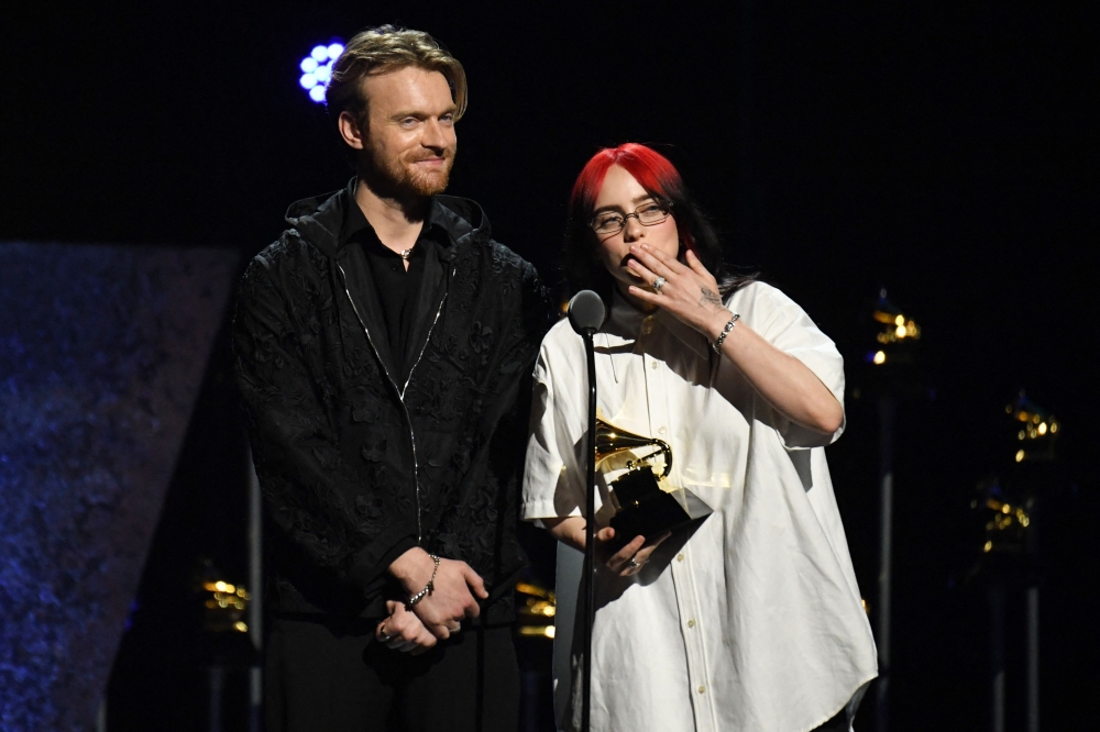 Finneas O'Connell and US singer songwriter Billie Eilish accept the award for best Song Written for Visual Media for 