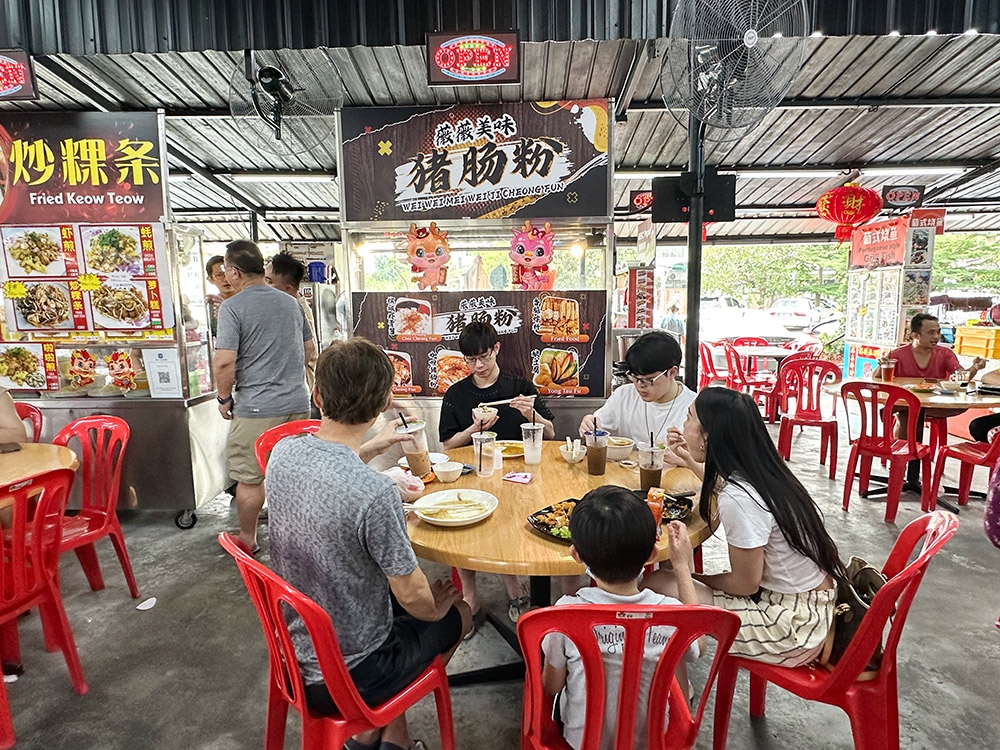Find the stall in the middle of the food court.