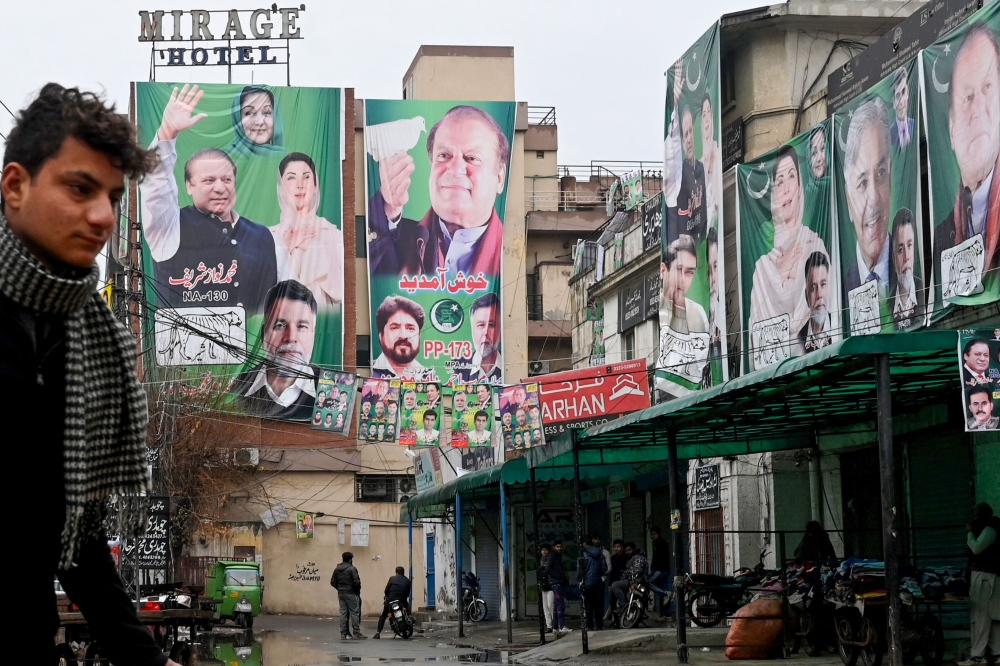 A street is festooned with posters of Pakistan's former Prime Minister and leader of the Pakistan Muslim League (PML) party, Nawaz Sharif in Lahore on February 4, 2024, ahead of national elections. — AFP pic