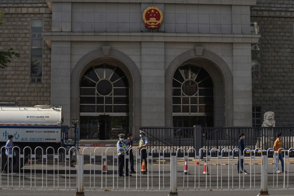 Police officers stand outside the Beijing Second Intermediate People’s Court ahead of the trial of Australian academic Yang Jun, also known as Yang Hengjun, on espionage charges in Beijing on May 27, 2021. Australia’s government said on February 5, 2024 writer Yang Jun has been given a suspended death sentence in China, describing it as ‘harrowing news’. — AFP pic