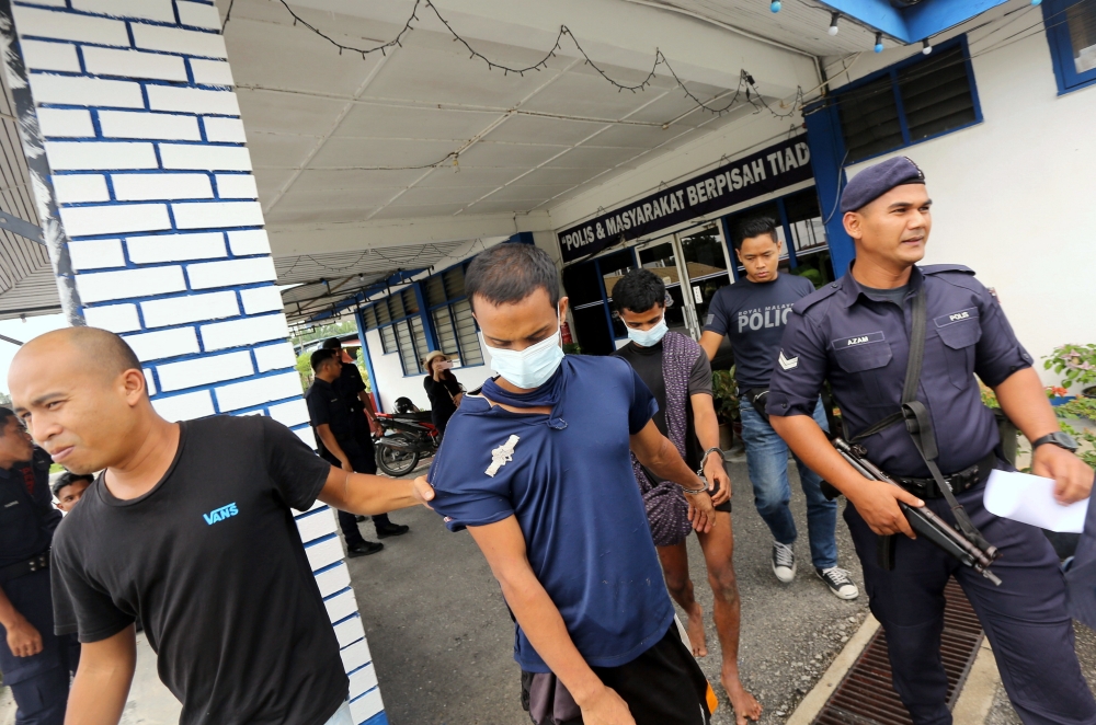 The two Rohingya male detainees, aged 18 and 23, were detained by the Sungkai task force and police patrols while walking in the Felda Sungai Klah oil palm plantation in Sungkai, February 5, 2024. — Bernama pic   