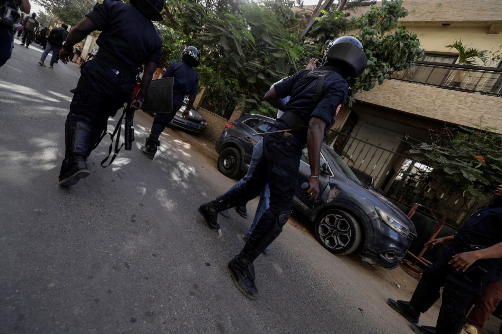 Riot police officers disperse Senegalese demonstrators  as they try to gather to protest the postponement of the February 25 presidential election, near  Senegal's National Assembly in Dakar, Senegal February 5, 2024. — Reuters pic
