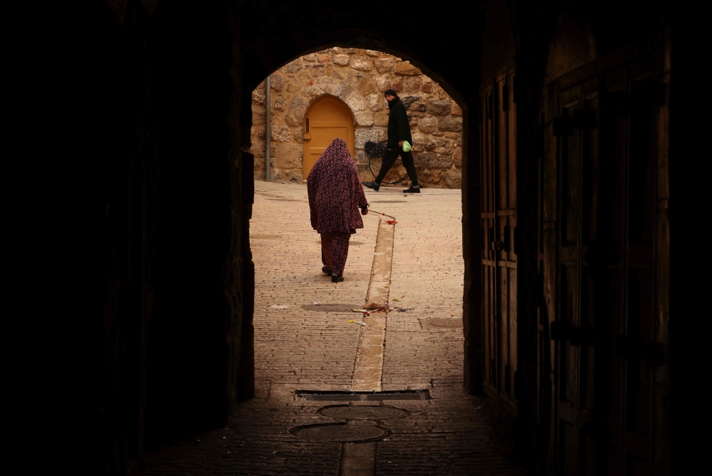 Palestinians walk in the empty streets of the old town of Hebron in the occupied West Bank on February 5, 2024, amid ongoing battles between Israel and the Palestinian militant group Hamas in Gaza. — AFP pic