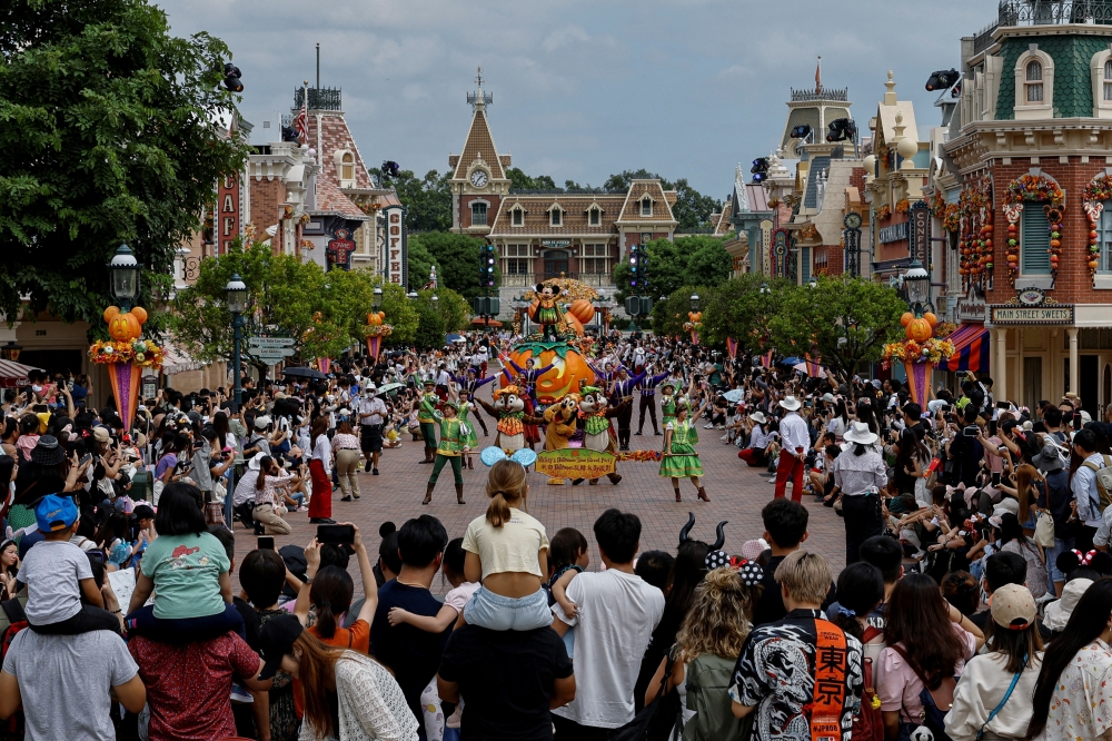 Visitors watch the Halloween program featuring Disney character Mickey Mouse at a parade at Hong Kong Disneyland, China October 13, 2023. — Reuters pic