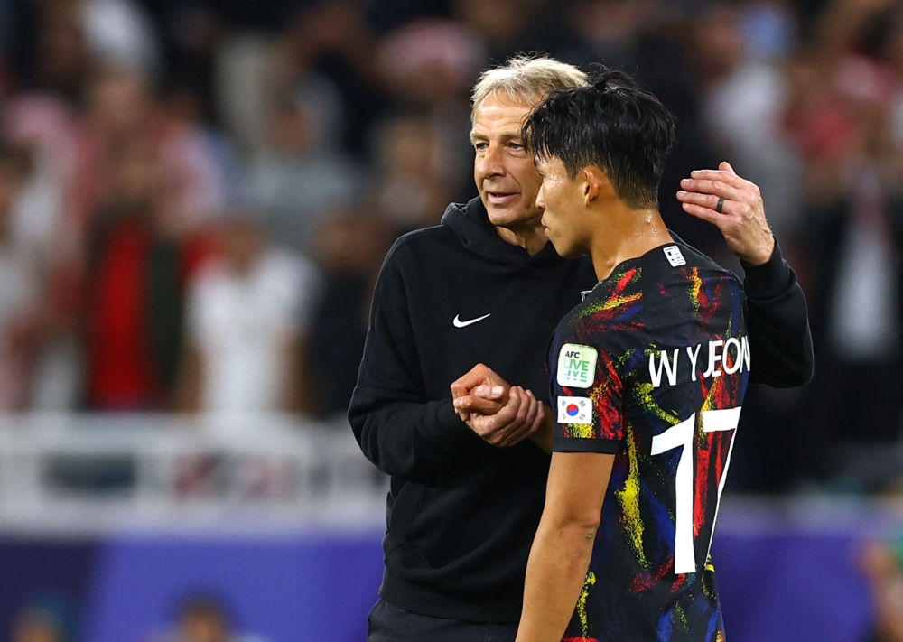 South Korea's Son Heung-Min and coach Jurgen Klinsmann look dejected after being eliminated from the AFC Asian Cup after their semi final match against Jordan at the Ahmed bin Ali Stadium, Al Rayyan February 6, 2024. — Reuters pic  