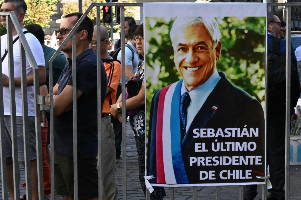 A portrait of the late former Chilean President Sebastian Pinera is seen outside the National Congress Palace in Santiago on February 7, 2024. — AFP pic