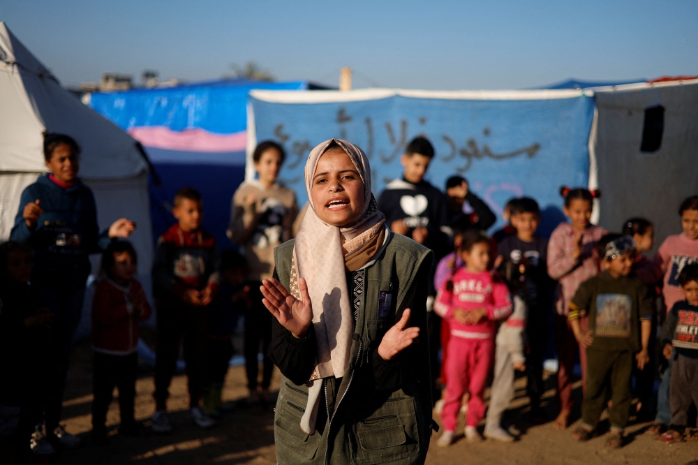Displaced Palestinian children, who fled their houses due to Israeli strikes, take part in an entertaining activity organised by local activists, at a school run by United Nations Relief and Works Agency (UNRWA), to support the mental health of the children, amid the ongoing conflict between Israel and Hamas, in Rafah in the southern Gaza Strip February 7, 2024. — Reuters pic