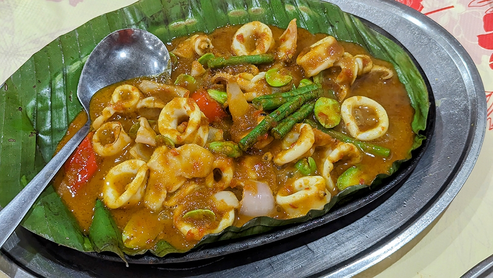 'Nyonya-style' squid on an iron plate.