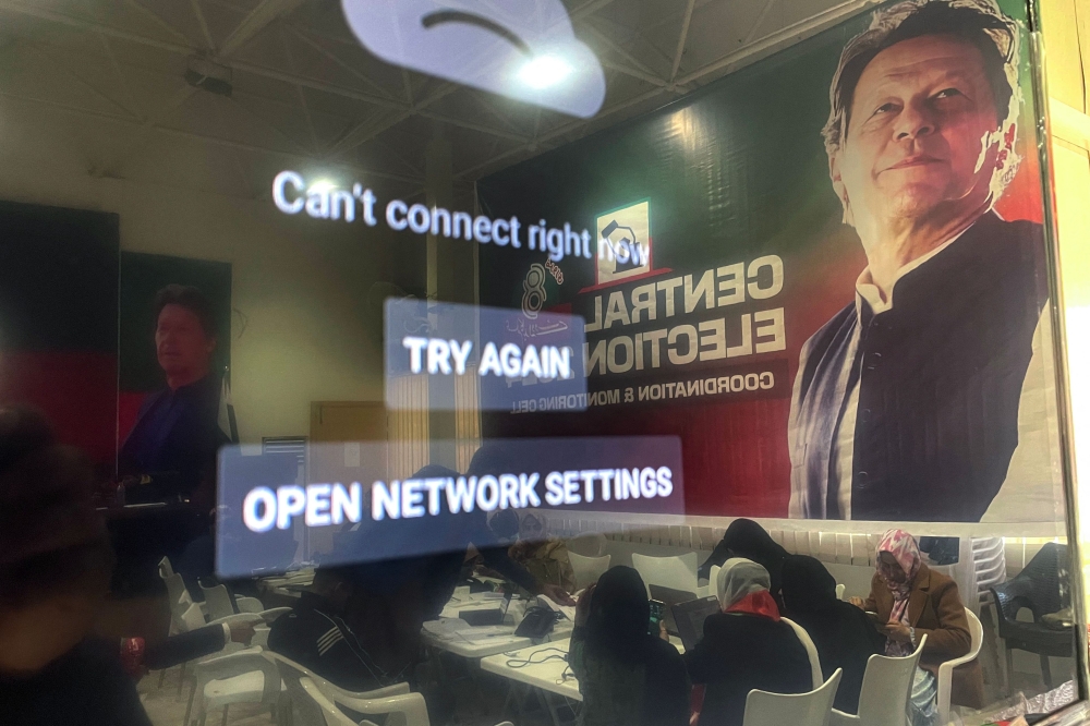 Workers are pictured at the central election monitoring cell of Pakistan Tehreek-e-Insaf (PTI) at the party office in Islamabad on February 8, 2024. — AFP pic 