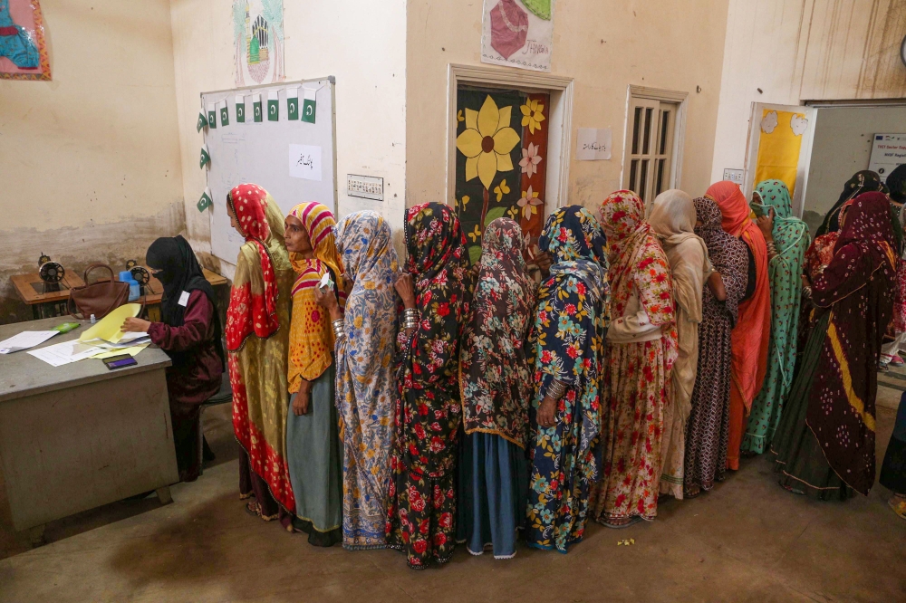 Millions of Pakistanis voted on February 8 in an election marred by rigging allegations, with authorities suspending mobile phone services throughout the day and the country’s most popular politician in jail. — AFP pic