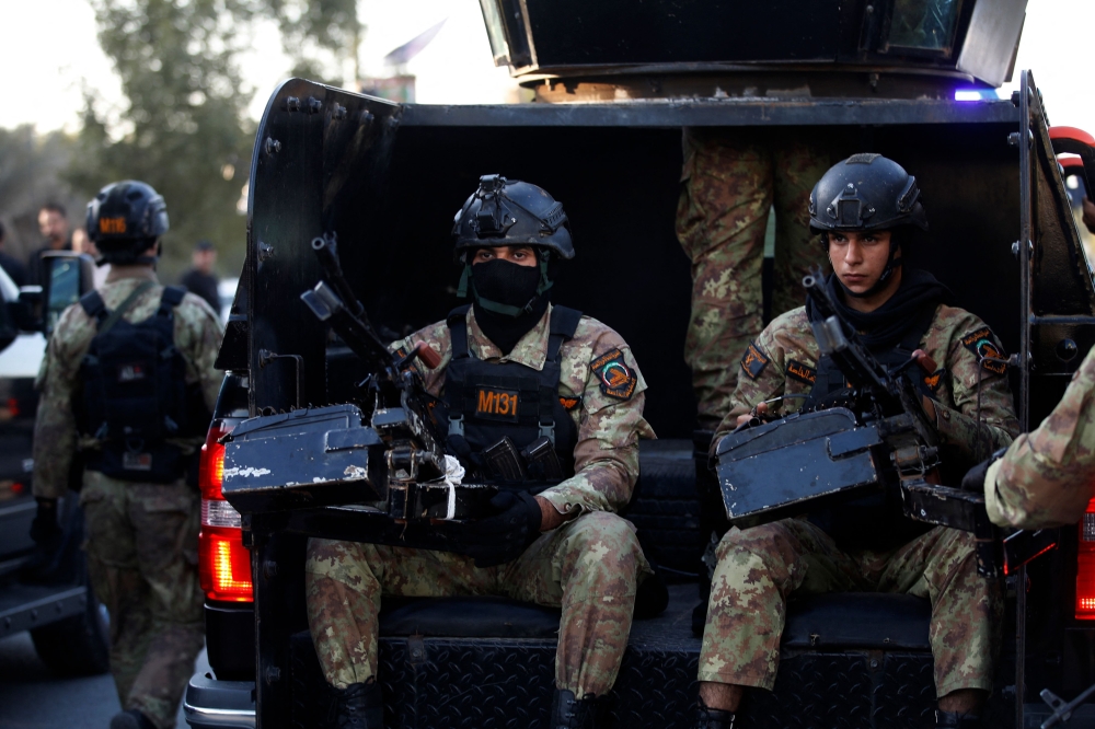 Members of Iraq’s Hashed al-Shaabi (Popular Mobilisation) keep guard during the funeral of Abu Baqr al-Saadi, a prominent leader in the Kataeb Hezbollah, who was killed in a strike carried out a day earlier by the US that targeted his car in a vital neighbourhood in Baghdad, on February 8, 2024. — AFP pic
